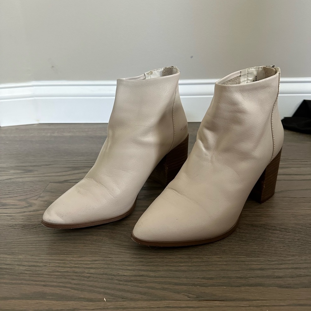 White ankle height booties with wooden heels